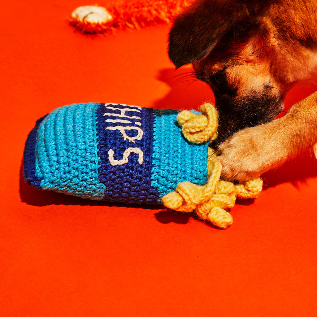 dog playing with crochet chips dog toy